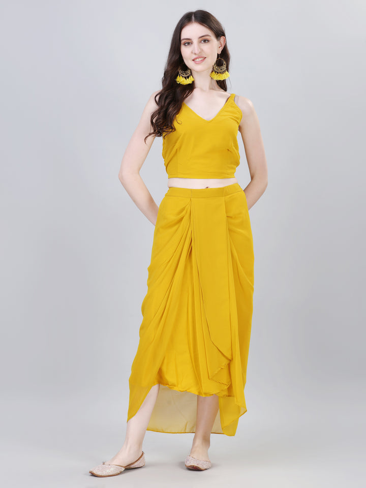 Woman in mustard yellow sleeveless crop top and draped skirt indo-western outfit – Modestouze Attires