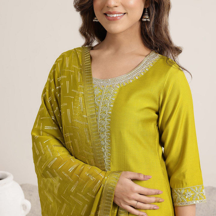 “Close-up of mustard Roman Silk kurta showing embroidered neckline and patterned dupatta.”