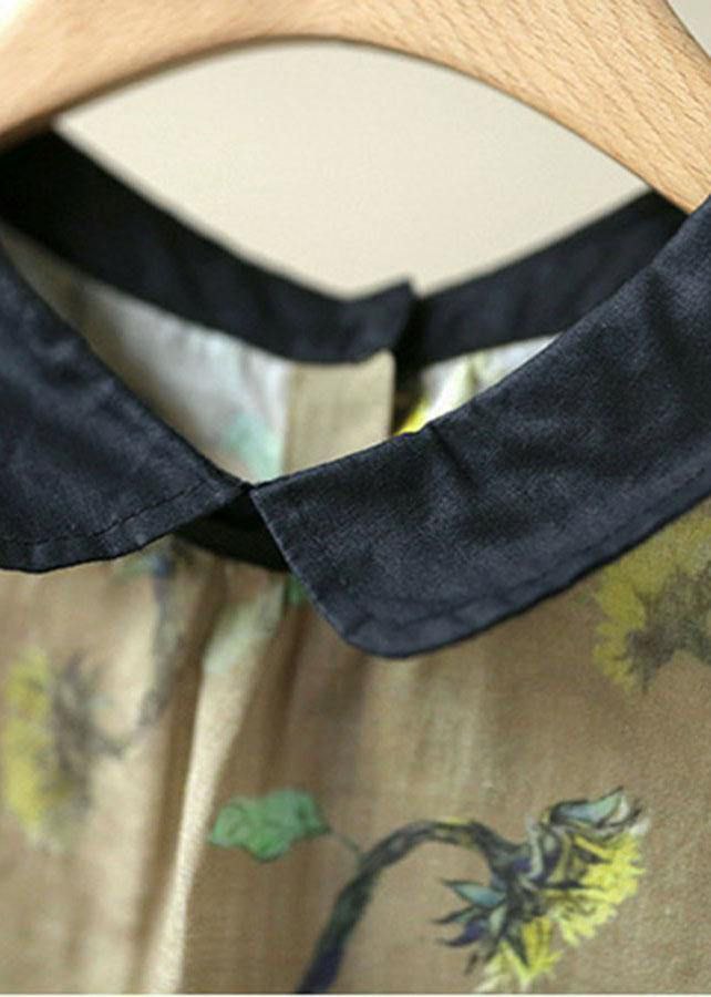 Close-up of a black collar on a garment with floral patterns.
