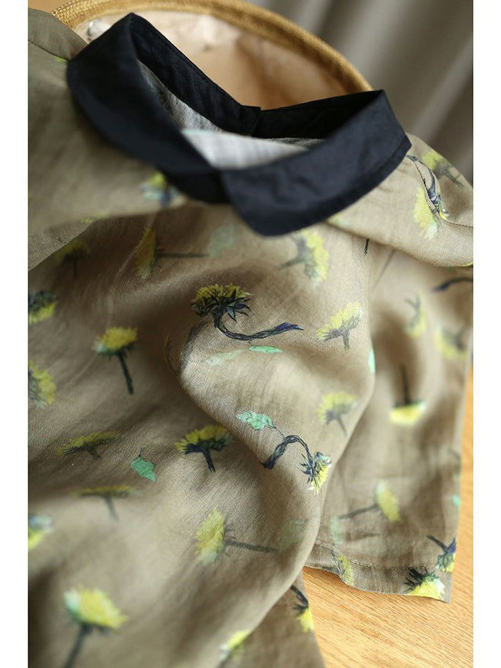 Close-up of a beige fabric with floral patterns and a black collar.