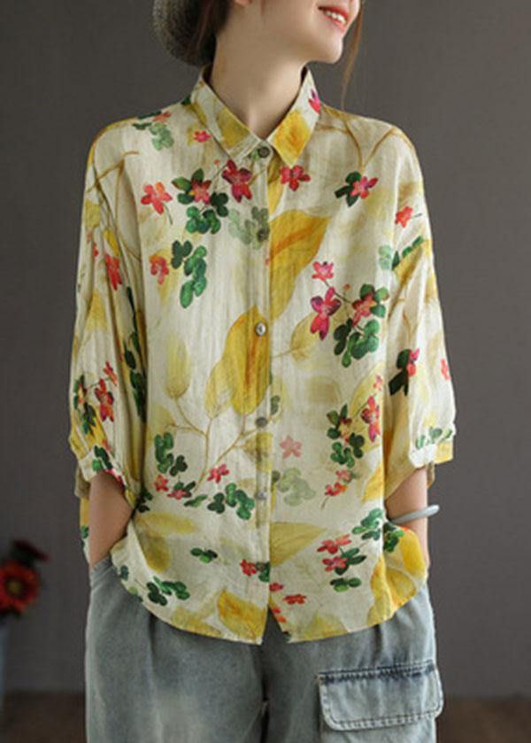 Person wearing a floral patterned shirt with a neutral background